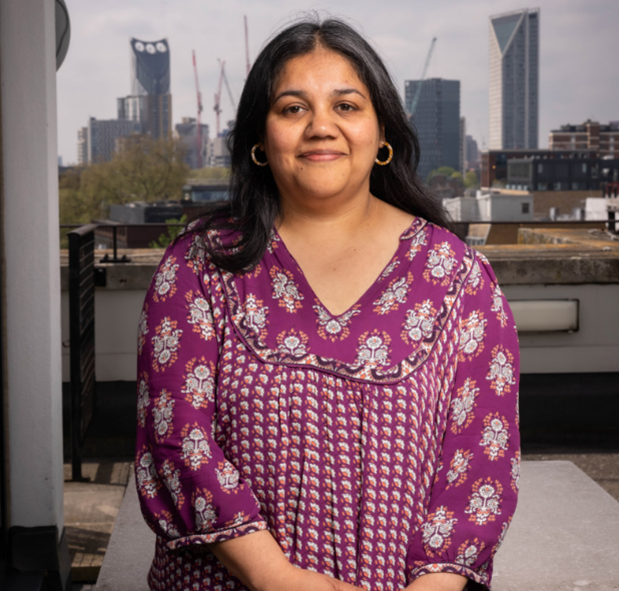 Dr Rini Paul, skyscrappers in the background